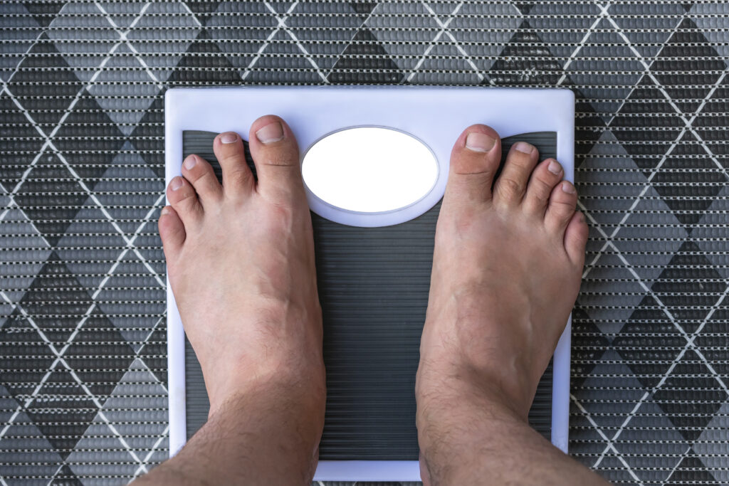 man is weighed on floor scales standing barefoot 2022 09 20 01 16 32 utc 1024x683 1