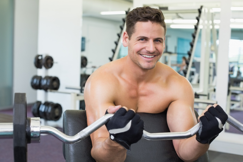 Man working out at the gym representing improved strength and energy from men’s hormone therapy in Parker CO