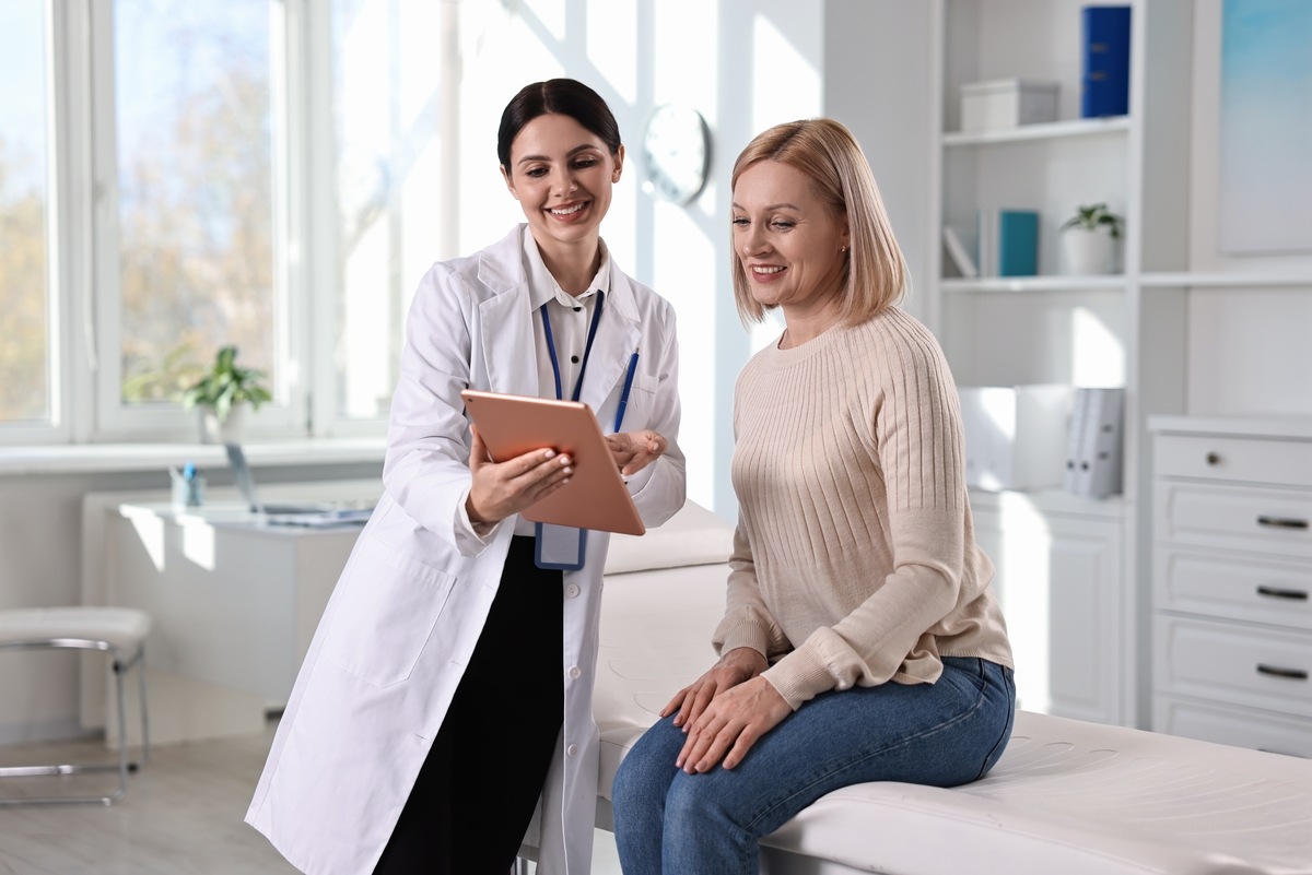 Woman in clinic consulting with healthcare provider about hormone replacement therapy in Parker, CO