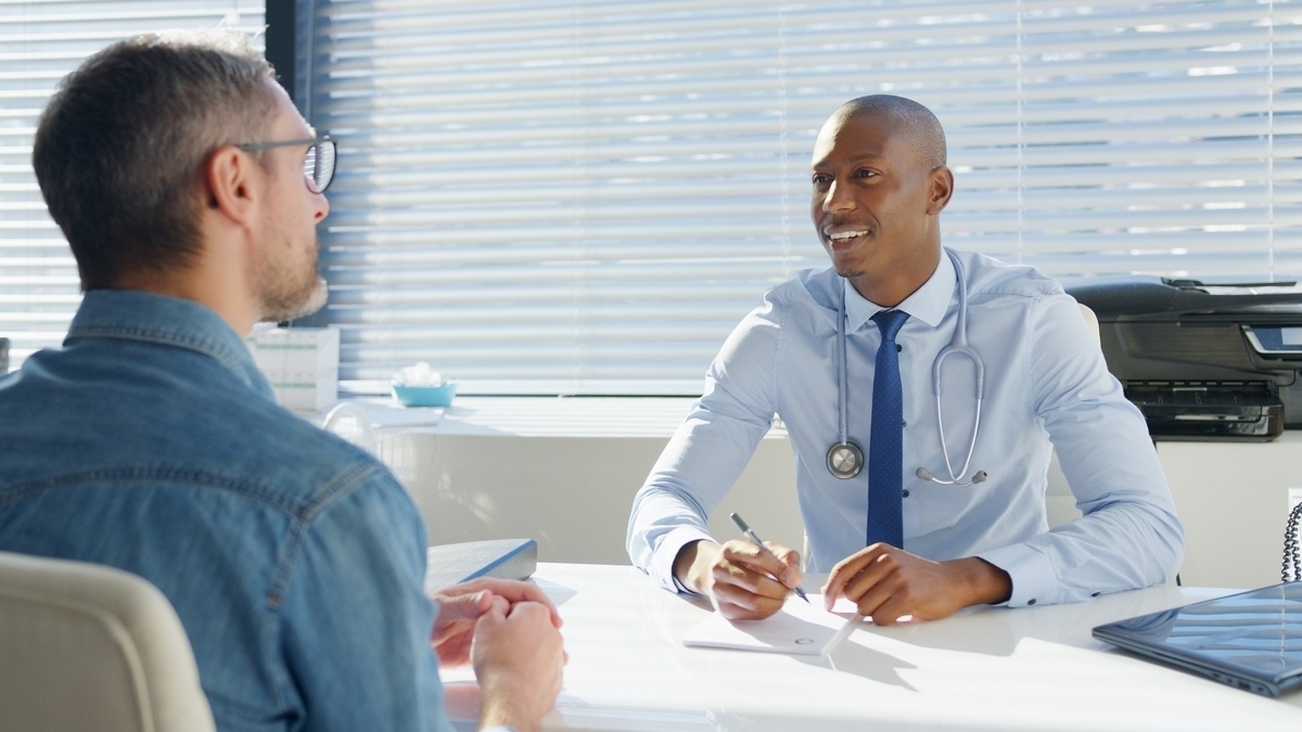 Man learning about TRT vs anabolic steroids during a consultation with his healthcare provider